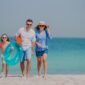 Family walking along a pristine Maldivian beach, embracing sustainable practices in the Maldives with eco-friendly travel choices and responsible tourism.