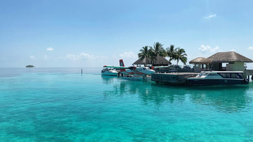 Elegant overwater villas in the Maldives surrounded by turquoise waters, showcasing the ultimate luxury experiences in the Maldives.