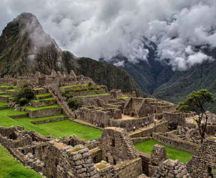 A breathtaking view of Machu Picchu, showcasing the ancient Incan ruins surrounded by lush green mountains, a must-visit destination for travelers exploring Peru