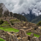 A breathtaking view of Machu Picchu, showcasing the ancient Incan ruins surrounded by lush green mountains, a must-visit destination for travelers exploring Peru