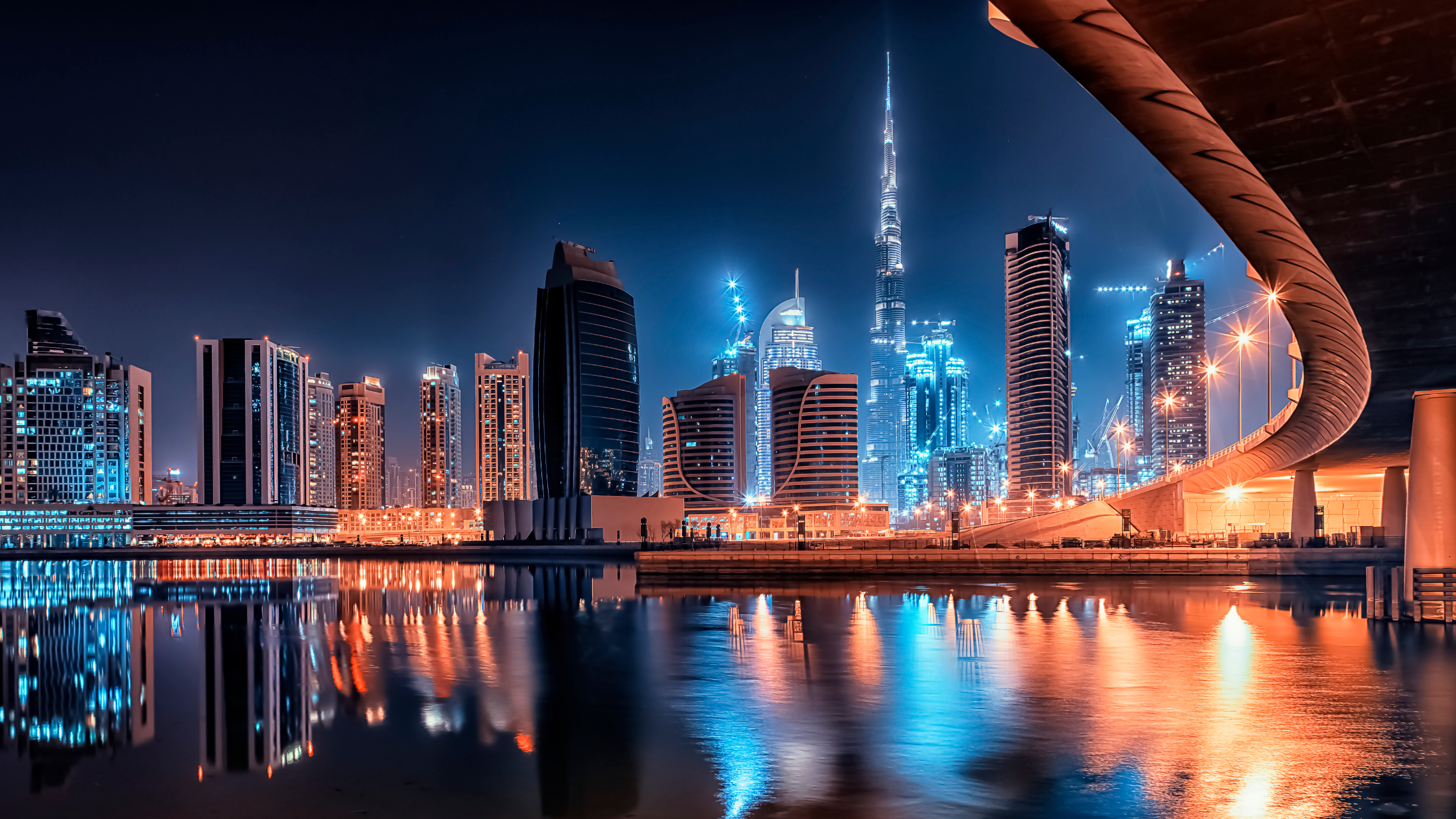 "Stunning night view of Dubai city skyline, featuring the illuminated Burj Khalifa and futuristic skyscrapers."